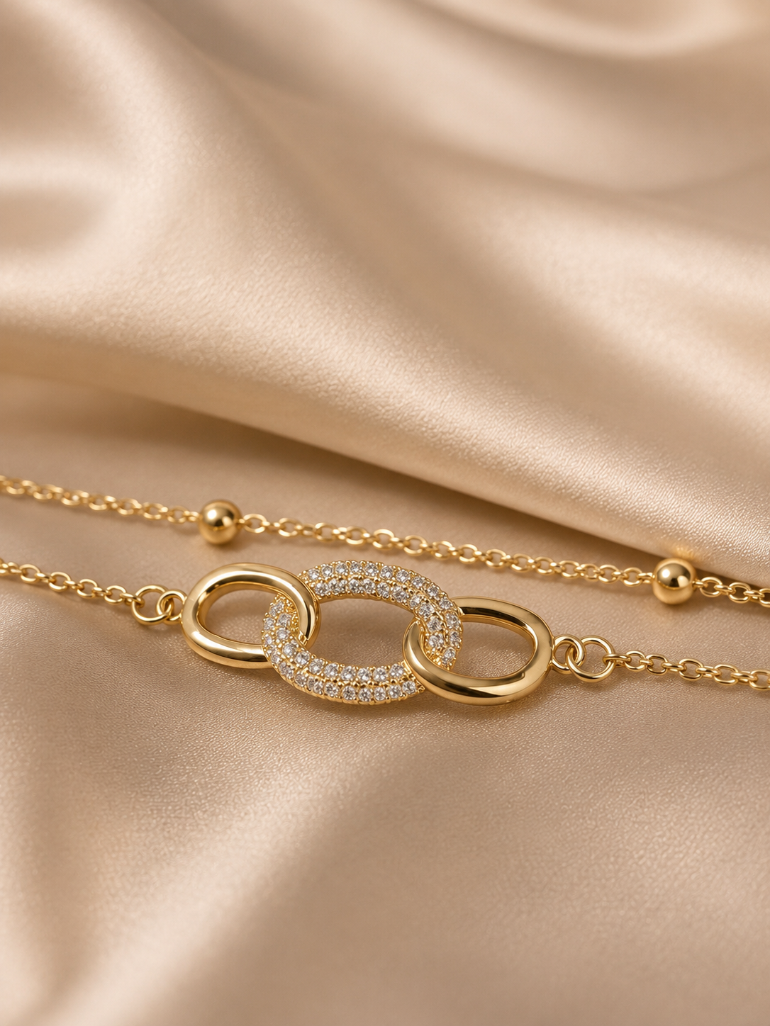 Interlink Dual Chain Bracelet by Ashaarya featuring a crystal-studded interlocking link in 18KT gold plated 316L stainless steel. Lightweight, anti-tarnish bracelet for women.