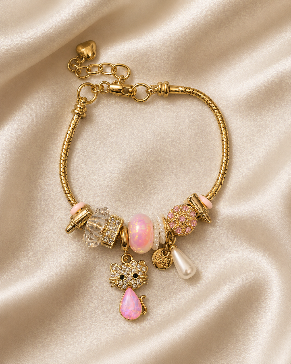 Kitty Keepsake Charm Bracelet by Ashaarya in 18KT gold tone with pink charms and crystal kitty pendant. cat charm bracelet, cute charm bracelet, gold charm bracelet for women, anti tarnish charm bracelet, 316L stainless steel bracelet, lightweight bracelet, pink charm bracelet, comfort jewellery, Ashaarya charm bracelet