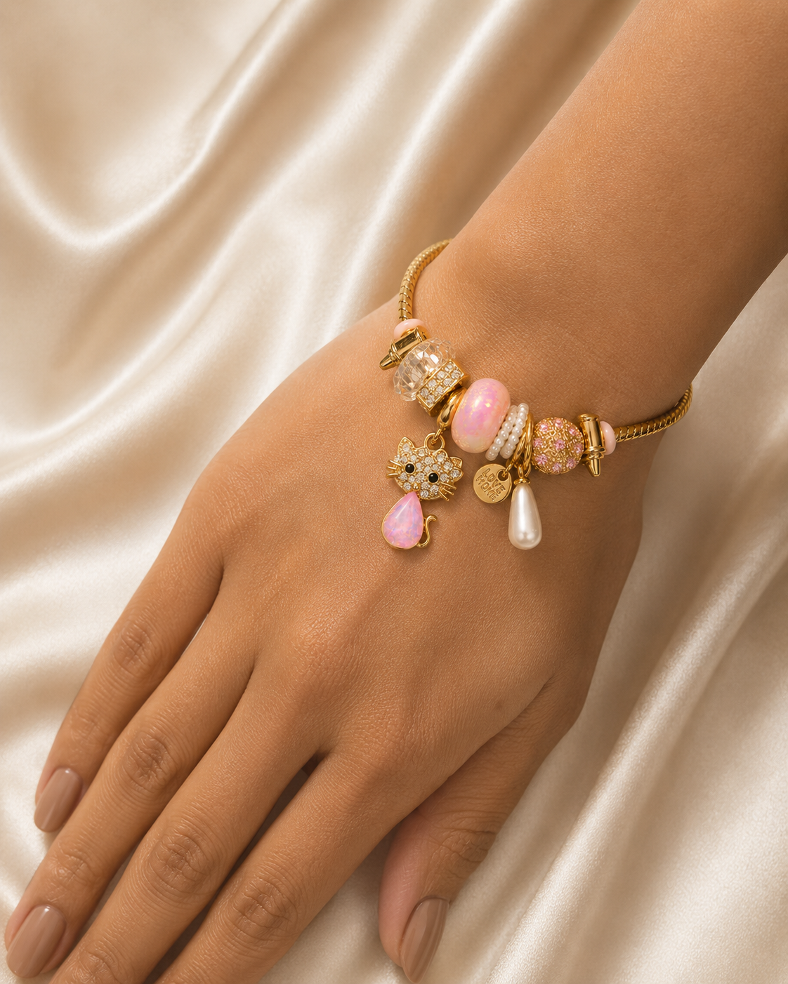 316L stainless steel Kitty Keepsake Charm Bracelet by Ashaarya with anti-tarnish gold finish.. cat charm bracelet, cute bracelet, charm bracelet for women, gold bracelet, anti tarnish jewellery, lightweight bracelet, stainless steel bracelet, pink jewellery, kawaii jewellery, everyday jewellery, gifting bracelet, comfort jewellery, Ashaarya, luxury charm bracelet, playful jewellery