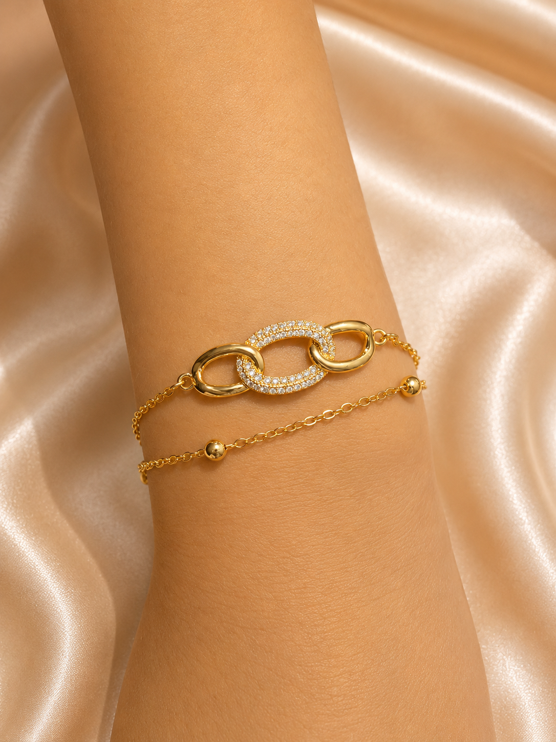 Interlink Dual Chain Bracelet by Ashaarya featuring a crystal-studded interlocking link in 18KT gold plated 316L stainless steel. Lightweight, anti-tarnish bracelet for women.