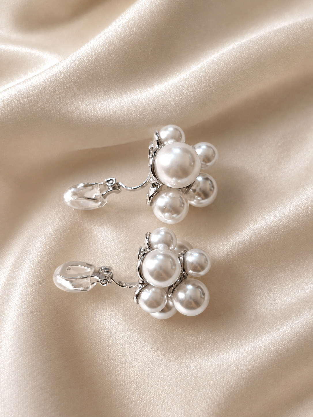 Lightweight pearl clip-on earrings designed as comfort jewellery with a delicate clustered flower-inspired pearl design