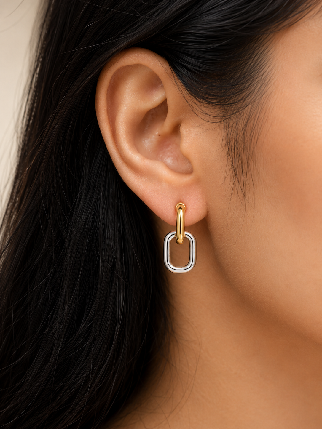 Close-up of an ear wearing a gold and silver hoop earring. two tone earrings, gold and silver earrings, stainless steel earrings, anti tarnish earrings, lightweight earrings, statement earrings for women, geometric earrings, modern earrings, link earrings, everyday earrings, skin friendly jewellery, comfort jewellery