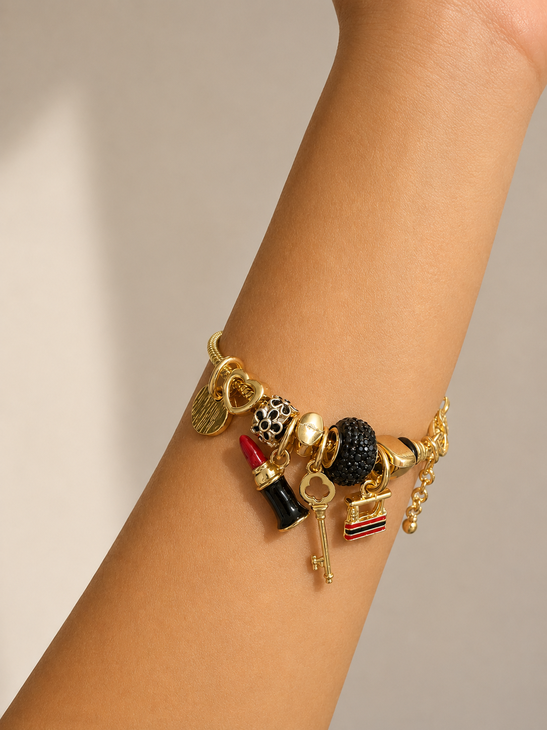 Women's comfort jewellery charm bracelet worn on wrist with premium gold-tone finish