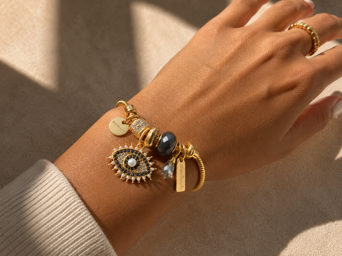 Close-up shot of luxury evil eye charms on Noor-E-Nazar bracelet with crystal accents and gold-tone detailing by Ashaarya.
