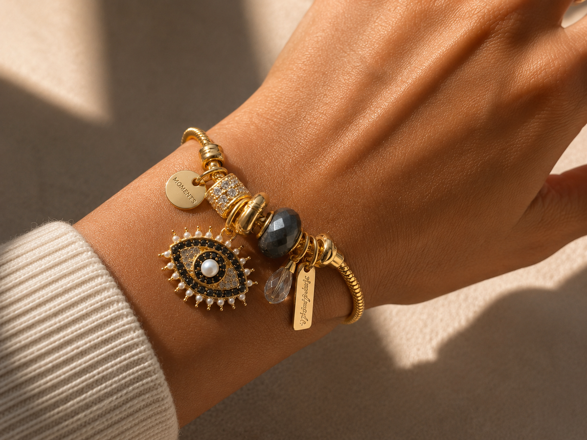 Hand wearing Noor-E-Nazar anti-tarnish charm bracelet featuring evil eye pendant and lightweight comfort jewellery styling.