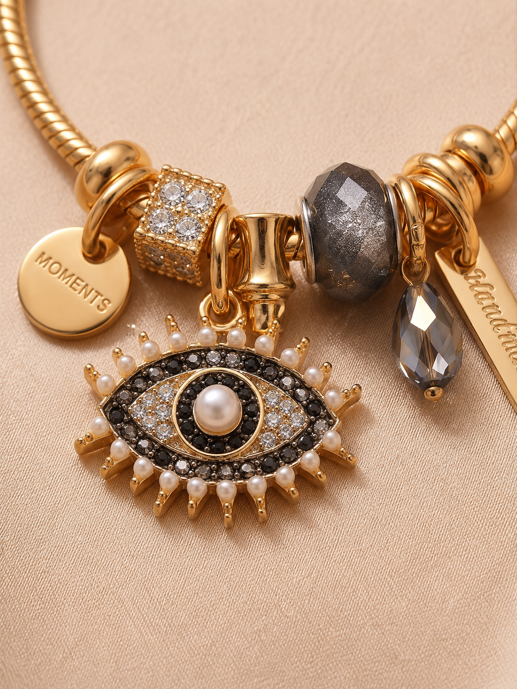 Anti-tarnish Noor-E-Nazar charm bracelet by Ashaarya featuring evil eye charm, crystal detailing and gold-tone comfort jewellery design on satin background.