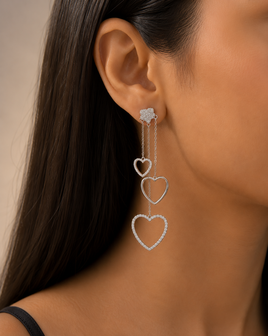 Close-up of a woman wearing heart-shaped earrings with a neutral background. 925 sterling silver earrings, sterling silver heart studs, silver heart earrings, 925 silver earrings for women, heart stud earrings, cubic zirconia earrings, hypoallergenic earrings, everyday silver jewellery, sterling silver studs, dainty silver earrings, silver jewellery India, Ashaarya