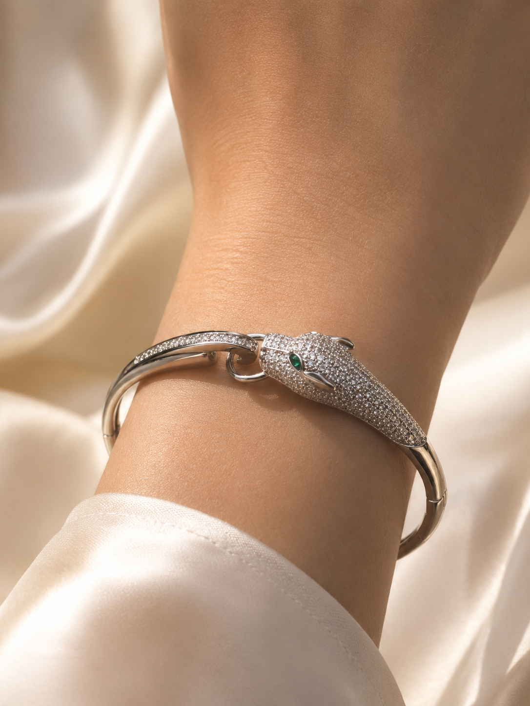 Panther cuff bracelet designed as statement comfort jewellery for women, featuring sparkling silver-tone detailing and green gemstone eyes