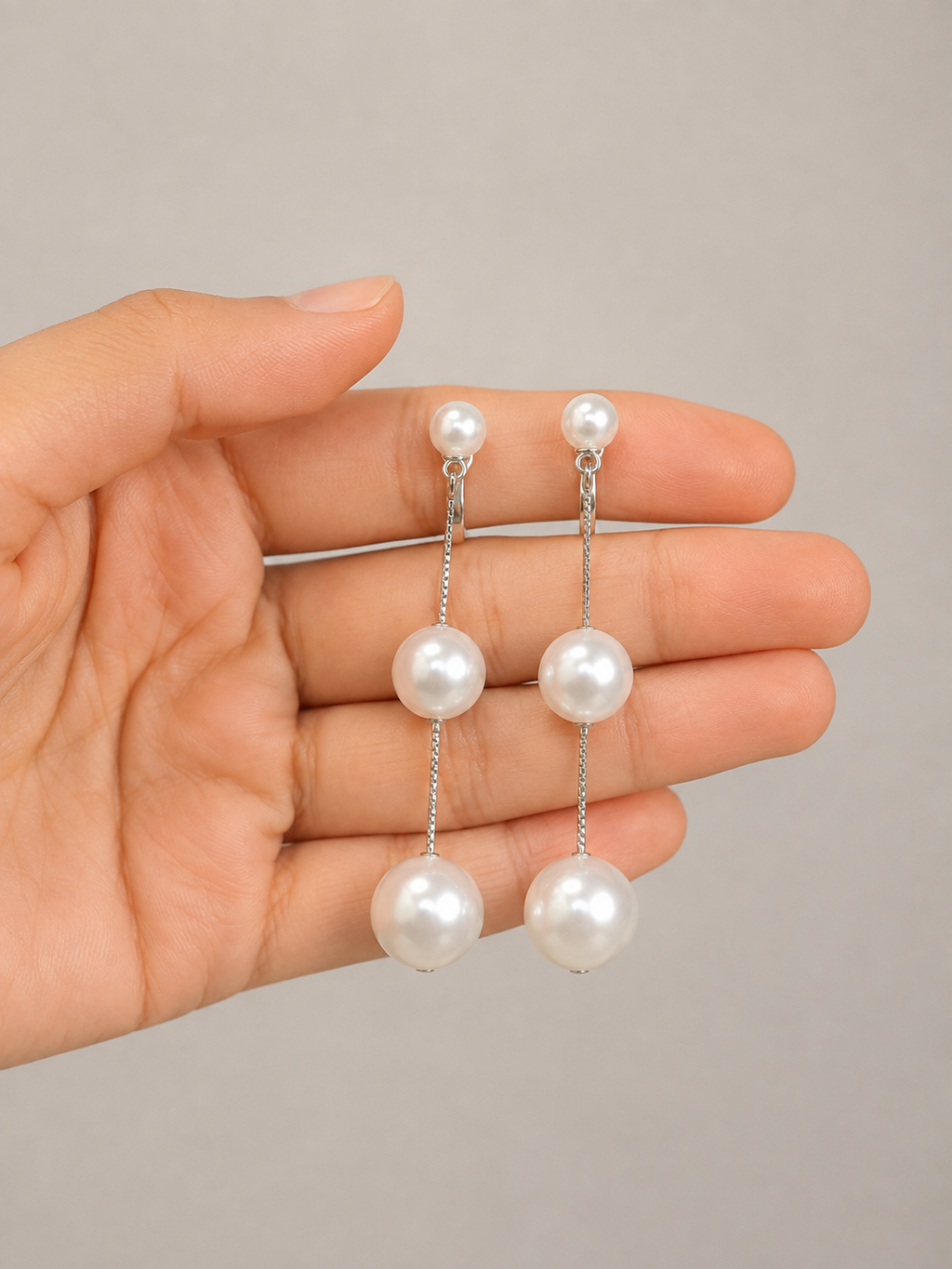 Pearl Cascade Drop Earrings by Ashaarya featuring three white pearl accents and delicate silver-tone chains.
