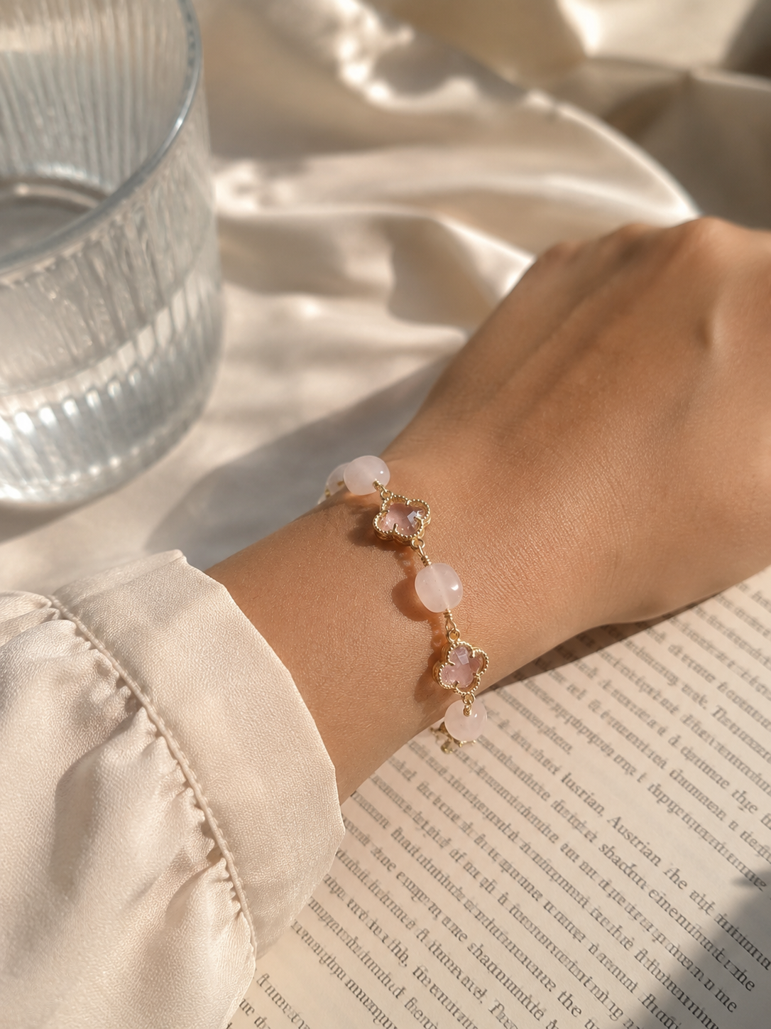 Pink natural stone bracelet for women with delicate gold-tone links and floral-inspired stone accents for everyday wear