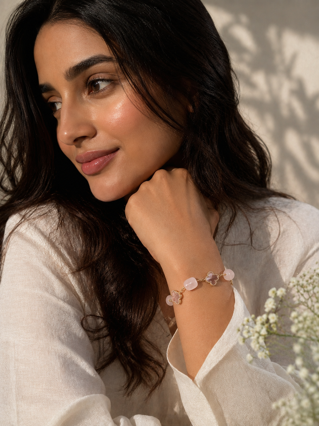 Pink stone bracelet for women with polished natural stones, floral clover-shaped accents and a delicate gold-tone chain