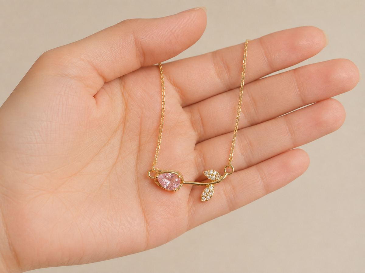 Pink stone necklace for women with a minimalist gold-tone chain and delicate leaf accent, perfect for everyday wear