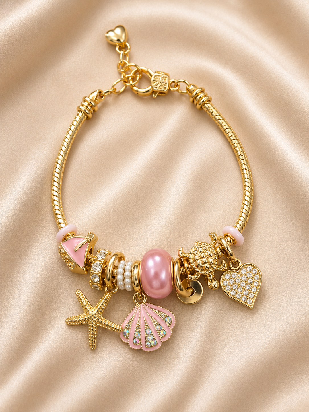 pink charm bracelet, ocean charm bracelet, beach charm bracelet, gold charm bracelet for women, seashell charm bracelet, turtle charm bracelet, 18KT gold plated bracelet, anti tarnish bracelet, stainless steel charm bracelet, lightweight charm bracelet, hypoallergenic bracelet, aesthetic charm bracelet, vacation jewellery, women's charm bracelet, Ashaarya charm bracelet