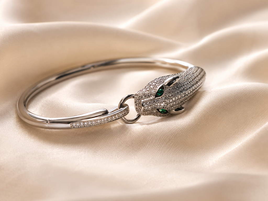 Silver animal cuff bracelet for women featuring a detailed panther head, green gemstone eyes and intricate sparkling stone accents
