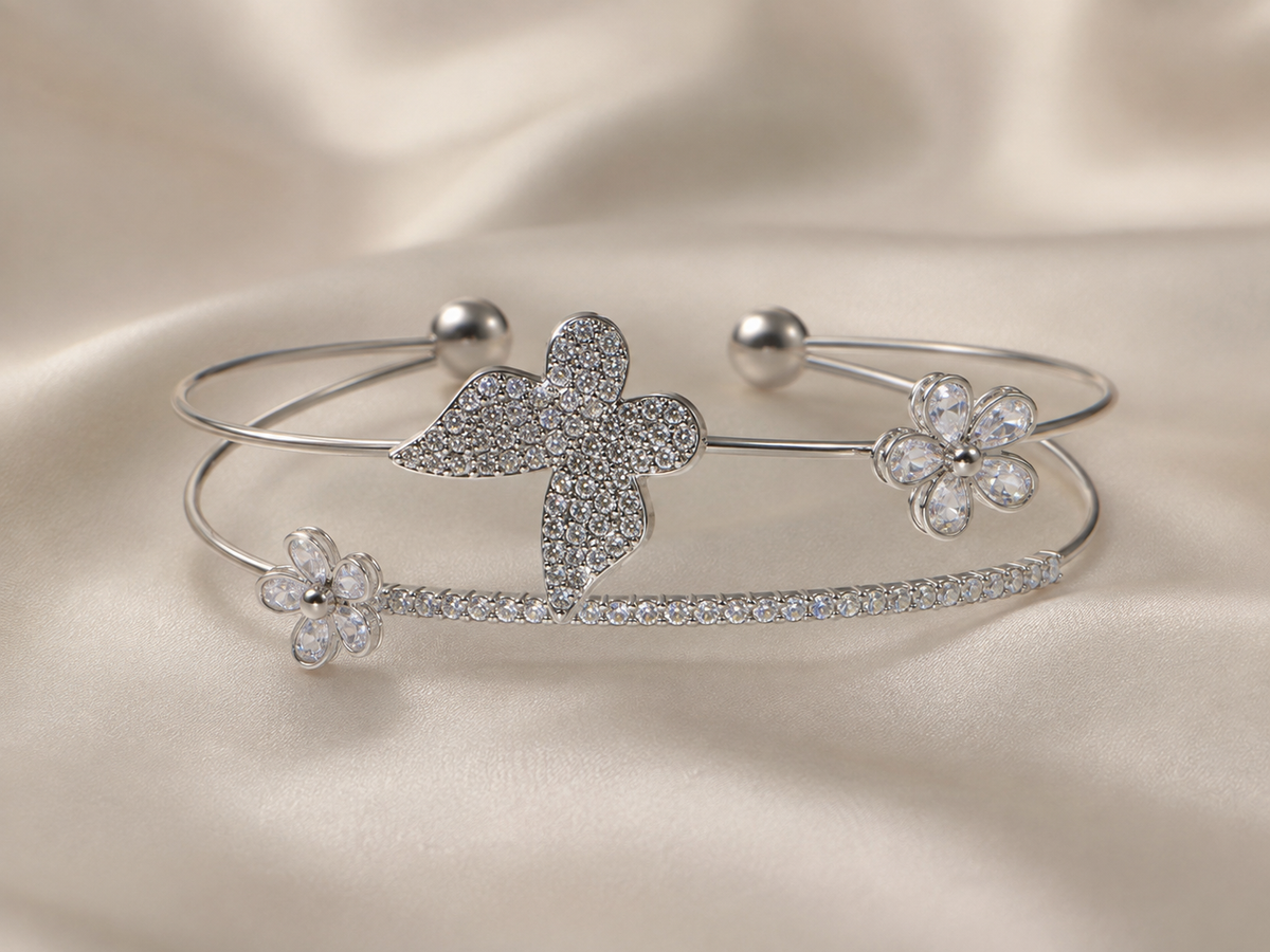 Close-up of the sparkling butterfly motif on Ashaarya's silver-tone bracelet.

