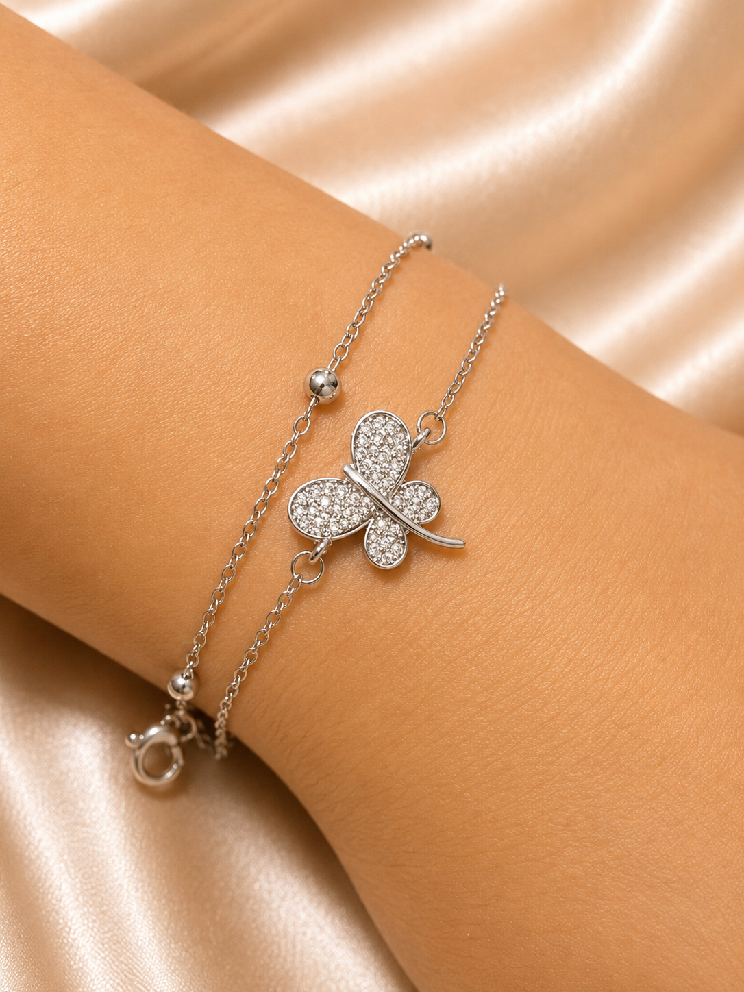The Becoming Bracelet by Ashaarya featuring a sparkling silver butterfly charm on a dual-chain anti-tarnish 316L stainless steel bracelet for women.
