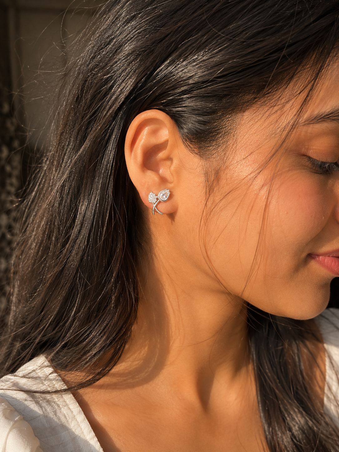 Silver crystal clip-on earrings for women designed for a no-piercing look with an elegant floral and pear-shaped crystal design