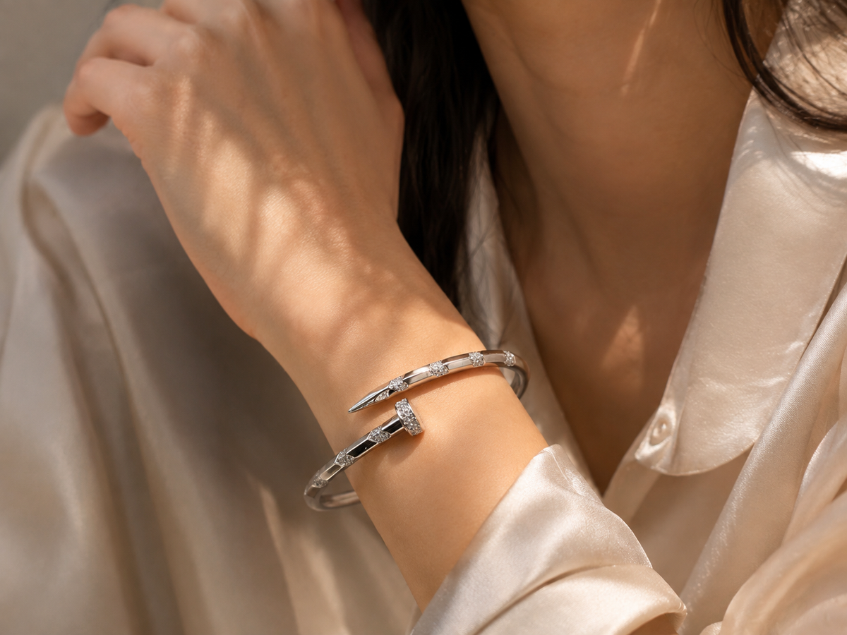 Silver cuff bracelet for women with a modern open design and sparkling crystal accents along the front