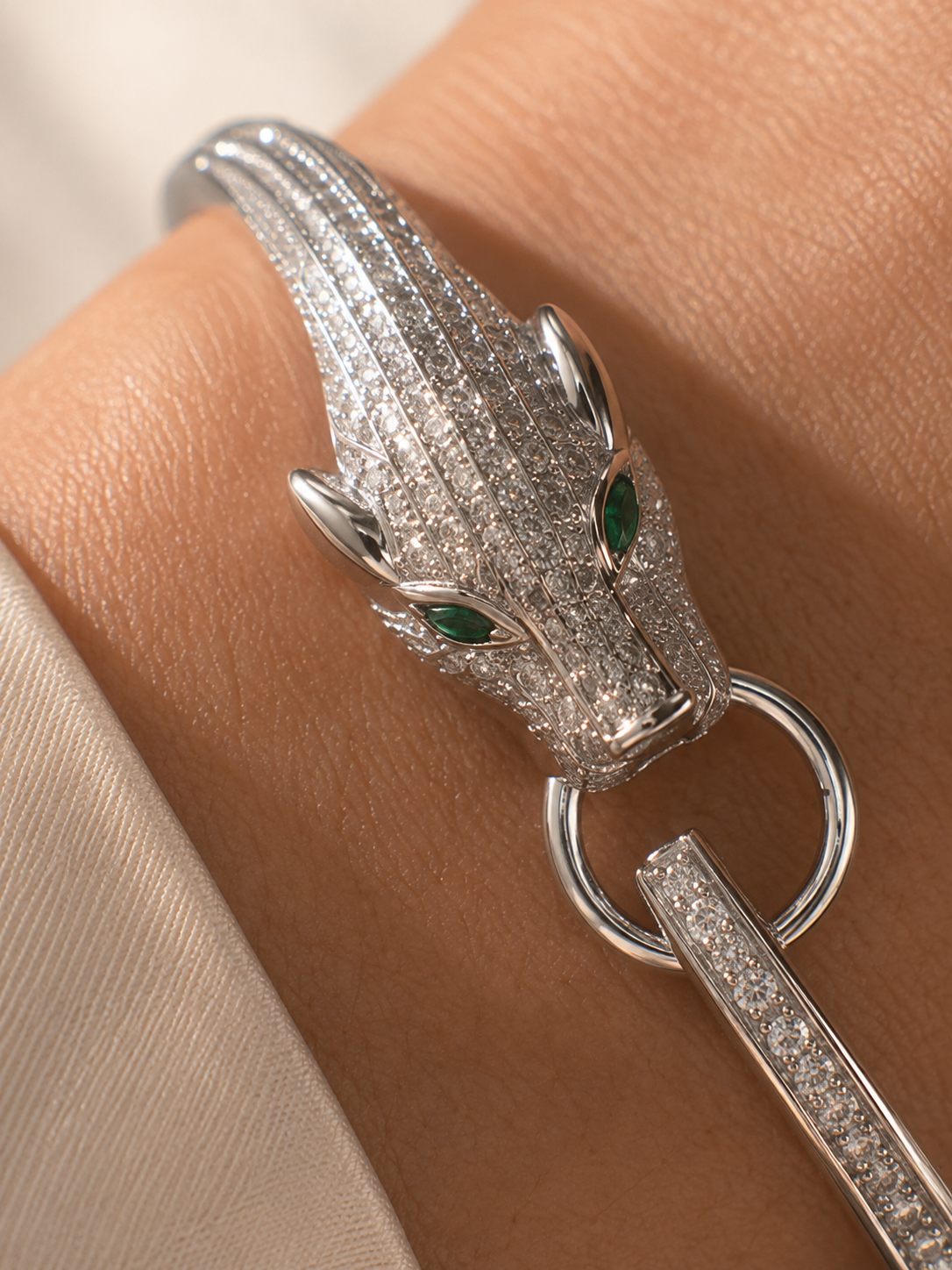 Silver panther bracelet for women with a sculpted animal-head design, pavé crystal detailing and striking green eyes