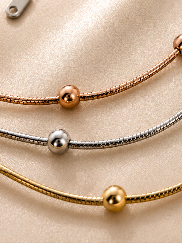 Trio Harmony Necklace by Ashaarya featuring 18KT gold tone, silver tone and rose gold tone layered beaded chains crafted in anti-tarnish 316L stainless steel.