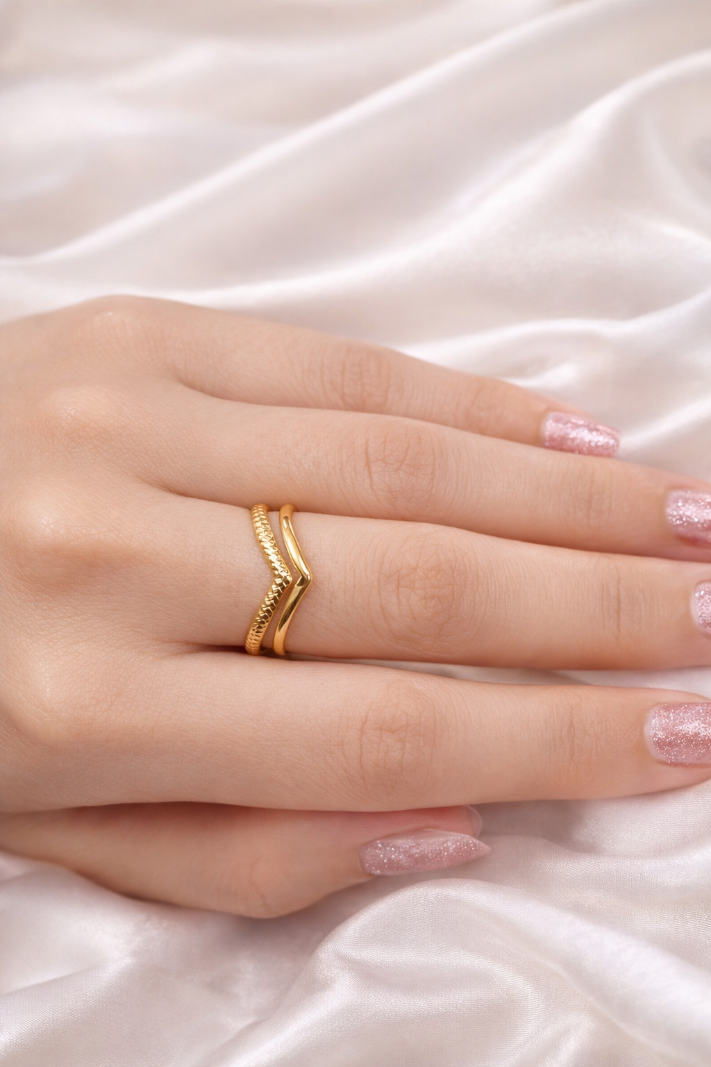 Adjustable open back V shaped ring for women – anti tarnish comfort jewellery silver rings for girls Gold ring on a finger with a soft white fabric background