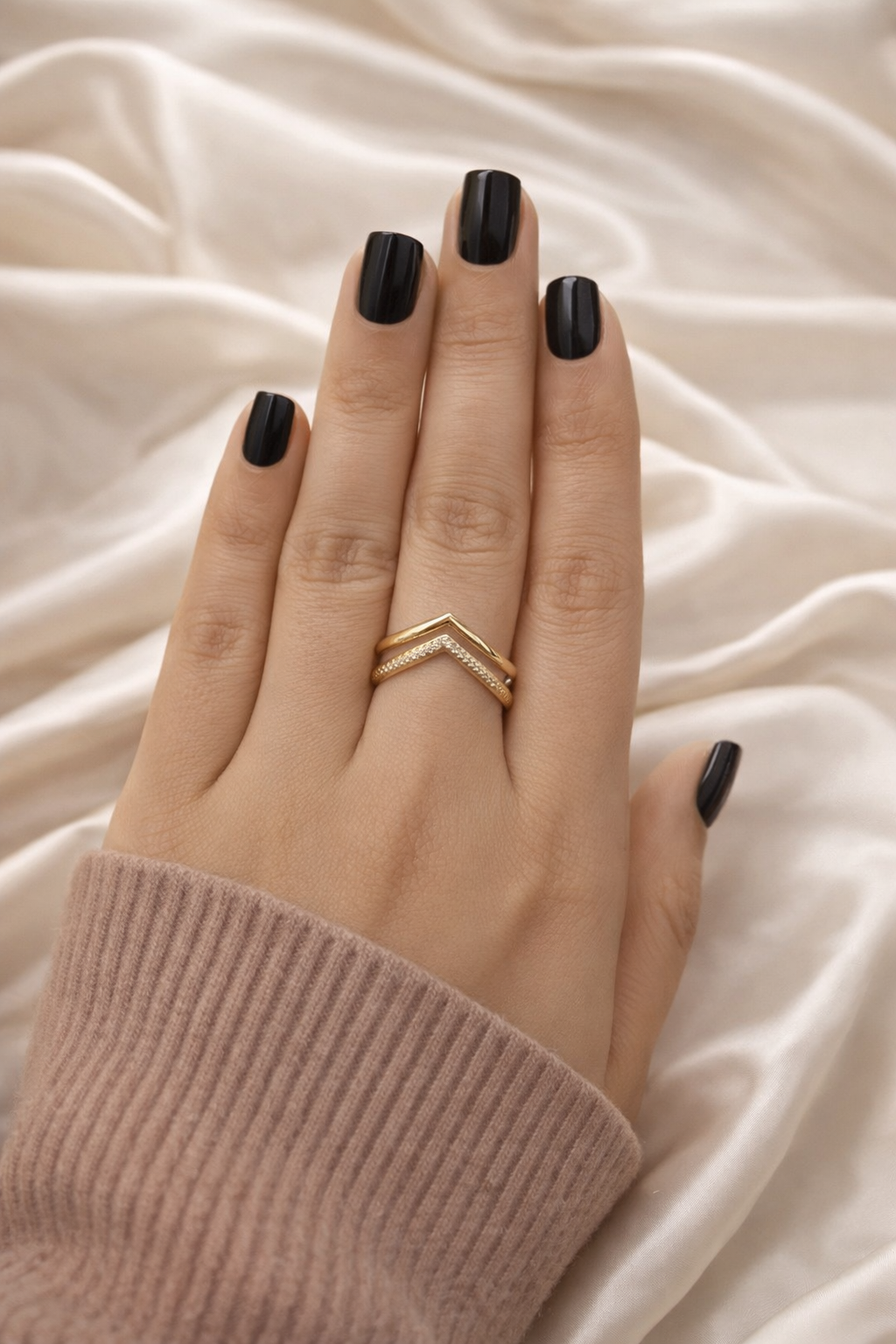 Minimal chevron V shaped ring anti tarnish gold finish – stackable comfort jewellery ring Hand with black nail polish wearing a gold ring on a beige fabric background