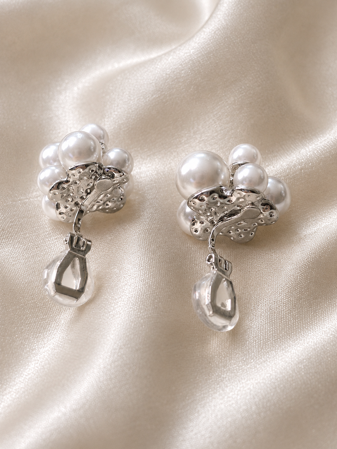 White pearl flower clip-on earrings with layered round pearls and an elegant no-piercing design